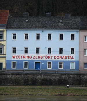 Plakat von Westring-Gegner auf einem Gebäude an der Oberen Donaulände